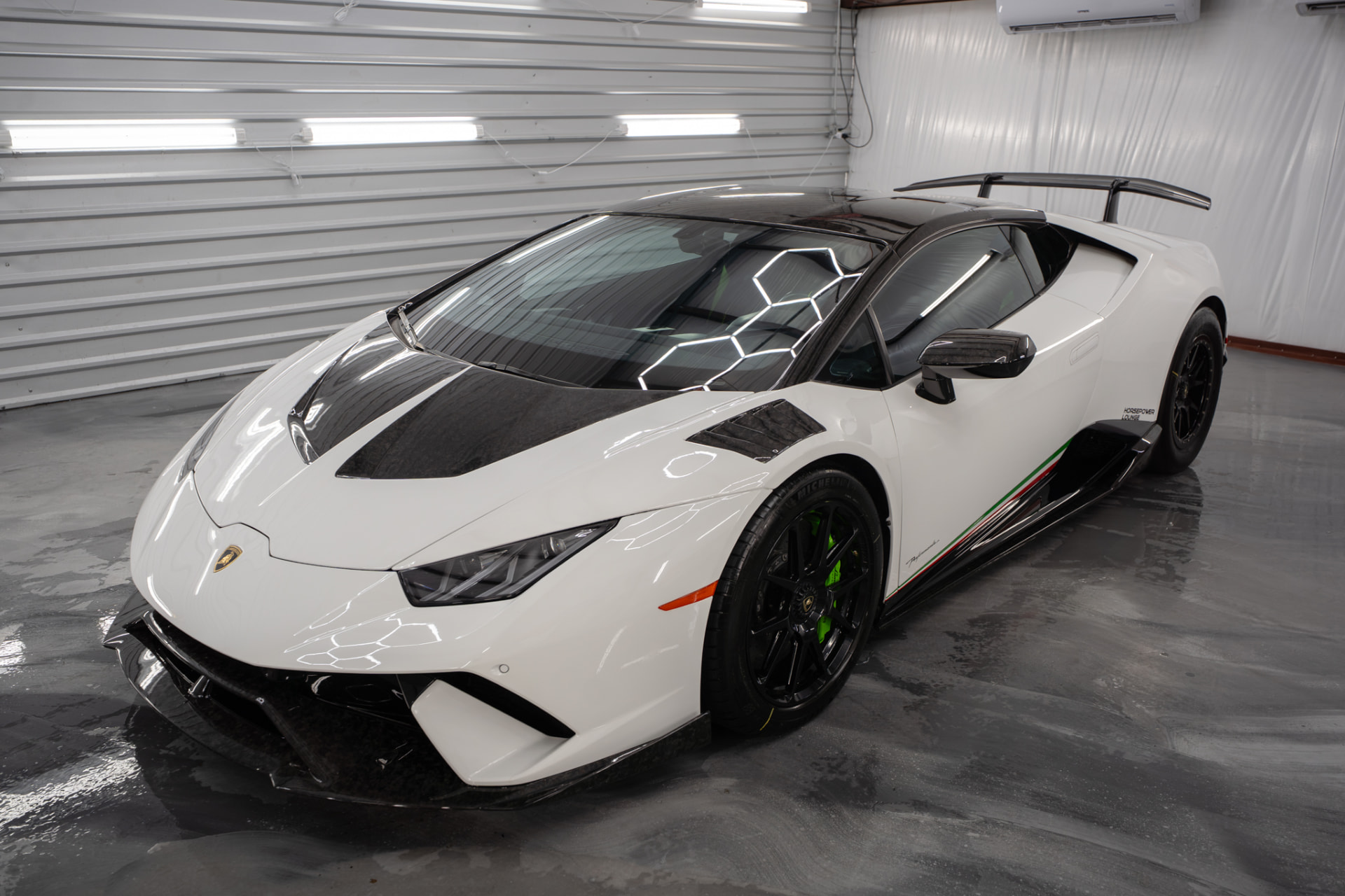 White Lamborghini with a deep-gloss ceramic coated finish at JJ’s Car Care in Terrell