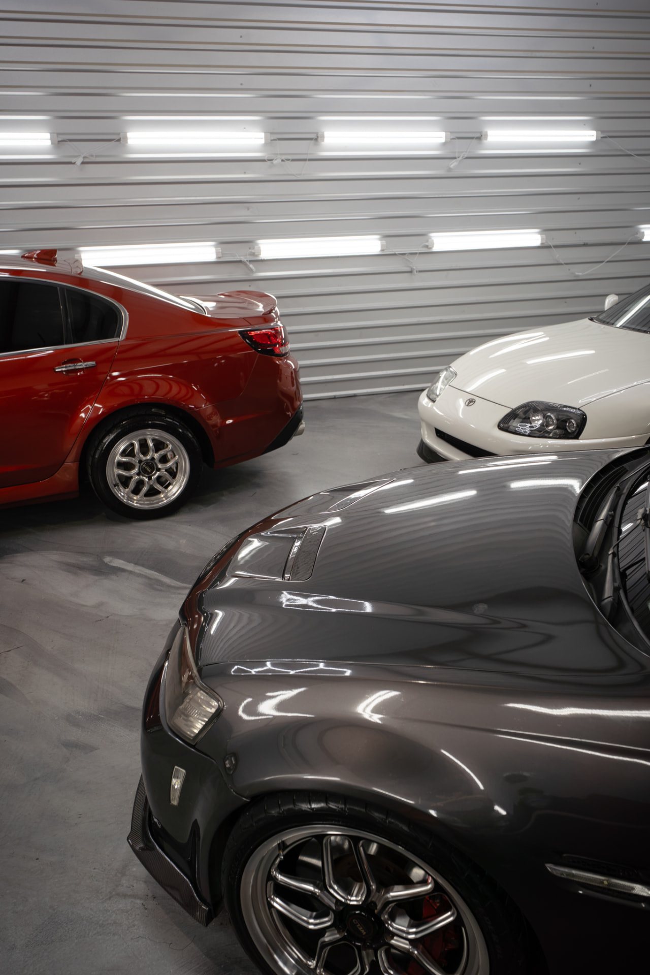 Vehicles under the shop lights during preparation at JJ’s Car Care in Terrell