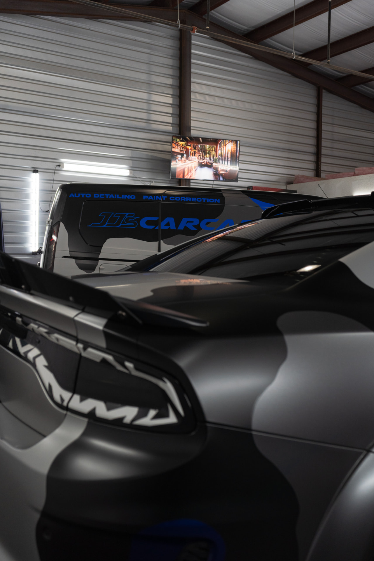 Dodge Charger with a matte camouflage wrap and custom wrapped taillights at JJ’s Car Care in Terrell